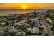 Aerial sunset view of a waterfront home with beach access and a neighborhood setting at 1245 Gulf Blvd, Englewood, FL 34223