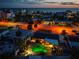Sunset aerial view of illuminated home with a private pool and close proximity to beach and waterfront at 1245 Gulf Blvd, Englewood, FL 34223