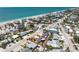 Stunning aerial view of a charming coastal home near the beach with turquoise waters and beautiful beachfront homes nearby at 1245 Gulf Blvd, Englewood, FL 34223
