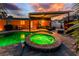 Picturesque backyard showcasing a pool, spa, covered patio, outdoor seating, and lush landscaping at 1245 Gulf Blvd, Englewood, FL 34223