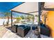 Charming backyard featuring a refreshing pool, spa, covered patio, and stylish outdoor seating arrangement at 1245 Gulf Blvd, Englewood, FL 34223