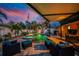Backyard oasis featuring an in-ground pool and hot tub surrounded by lush landscaping, perfect for relaxation at 1245 Gulf Blvd, Englewood, FL 34223