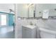 Bathroom with granite-topped vanity, mirror, tile backsplash, and views to the living area at 1245 Gulf Blvd, Englewood, FL 34223