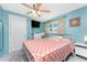 Bright bedroom features a ceiling fan, mounted TV, and natural light from the window at 1245 Gulf Blvd, Englewood, FL 34223