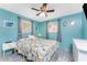 Bedroom featuring a tropical theme, ceiling fan, and two windows for great light at 1245 Gulf Blvd, Englewood, FL 34223