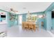 Bright dining room featuring a wooden table and themed decor adjacent to a window with palm tree views at 1245 Gulf Blvd, Englewood, FL 34223