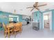 Open-concept dining room shows connection to the kitchen, living room, and bathroom at 1245 Gulf Blvd, Englewood, FL 34223