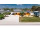 Attractive one-story home has an eye-catching exterior, pristine lawn, and a well-maintained driveway at 1245 Gulf Blvd, Englewood, FL 34223