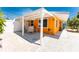 Side exterior view of the home highlighting the patio at 1245 Gulf Blvd, Englewood, FL 34223