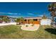 Charming single-story home boasts a vibrant exterior paint, well-manicured lawn, and beautiful landscaping at 1245 Gulf Blvd, Englewood, FL 34223
