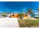 Exterior front elevation showing the landscaped yard and driveway at 1245 Gulf Blvd, Englewood, FL 34223