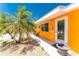 Welcoming entry way of a well-maintained home with palm trees and gravel landscaping at 1245 Gulf Blvd, Englewood, FL 34223