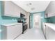 Modern kitchen features gray cabinetry, stainless steel appliances, and a convenient back door at 1245 Gulf Blvd, Englewood, FL 34223