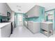 Modern kitchen with gray cabinetry, stainless steel appliances, and plenty of counter space, offering a clean and functional design at 1245 Gulf Blvd, Englewood, FL 34223