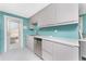 The kitchen showcases modern stainless steel appliances, minimalist gray cabinetry, and a backyard view at 1245 Gulf Blvd, Englewood, FL 34223