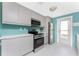 Sleek kitchen showcasing stainless steel appliances and ample cabinetry with a view to the outside at 1245 Gulf Blvd, Englewood, FL 34223