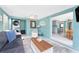 Comfortable living room flows to kitchen and dining areas featuring a modern sofa, bright windows and laundry at 1245 Gulf Blvd, Englewood, FL 34223