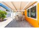 Outdoor patio features a dining table, chairs, and a covered roof, perfect for enjoying meals outside at 1245 Gulf Blvd, Englewood, FL 34223
