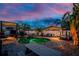 Evening shot of the outdoor patio featuring a pool, spa, entertainment area, and mature tropical landscaping at 1245 Gulf Blvd, Englewood, FL 34223