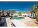 Outdoor patio featuring a pool, spa, entertainment area, and mature tropical landscaping at 1245 Gulf Blvd, Englewood, FL 34223