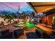 Backyard oasis with a glowing pool and spa, surrounded by a patio, seating, and lush landscaping at 1245 Gulf Blvd, Englewood, FL 34223