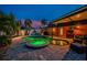 Backyard pool area with a hot tub, patio, and lush landscaping; perfect for outdoor entertaining and relaxation at 1245 Gulf Blvd, Englewood, FL 34223