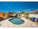 Inviting backyard pool area with a hot tub, covered patio, and lush tropical landscaping, perfect for outdoor relaxation at 1245 Gulf Blvd, Englewood, FL 34223