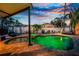 Beautiful backyard pool and spa with lush landscaping and a cozy seating area under a covered patio at 1245 Gulf Blvd, Englewood, FL 34223
