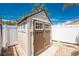 Exterior view of a backyard shed with double doors at 1245 Gulf Blvd, Englewood, FL 34223