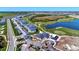 Expansive aerial view of the property featuring a lake, golf course and rows of townhomes at 12470 Wellen Golf St # 207, Venice, FL 34293