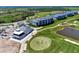 Aerial view of the property featuring a well-manicured golf course and modern residential buildings at 12470 Wellen Golf St # 207, Venice, FL 34293