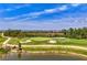 An aerial view of a golf course community with a pond at 12470 Wellen Golf St # 207, Venice, FL 34293
