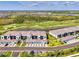 A gorgeous aerial view showcases the complex's prime location near a golf course, lakes, and manicured landscaping at 12470 Wellen Golf St # 207, Venice, FL 34293