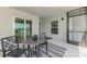 Outdoor balcony with table and chairs, ideal for relaxing and enjoying the surrounding views at 12470 Wellen Golf St # 207, Venice, FL 34293