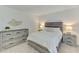 Cozy bedroom featuring a comfortable bed, dresser, and stylish decor at 12470 Wellen Golf St # 207, Venice, FL 34293