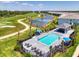 A beautiful community pool area that features a cabana, plenty of seating, a pristine pool, and golf course views at 12470 Wellen Golf St # 207, Venice, FL 34293