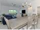 Open concept dining and living room with lots of natural light and modern decor at 12470 Wellen Golf St # 207, Venice, FL 34293