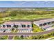 Beautiful exterior shot of condos overlooking a golf course and pond with attached garages at 12470 Wellen Golf St # 207, Venice, FL 34293