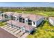 Exterior condo view with attached garages, screened in lanais and overlooking golf course at 12470 Wellen Golf St # 207, Venice, FL 34293