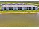 Back of building showcasing pond view, green space, and screened in patios at 12470 Wellen Golf St # 207, Venice, FL 34293