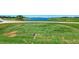 Scenic golf course view with a pristine green fairway leading to a tranquil lake at 12470 Wellen Golf St # 207, Venice, FL 34293