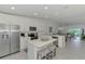 Bright open kitchen features stainless appliances, an island, and seating at 12470 Wellen Golf St # 207, Venice, FL 34293