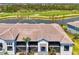 A stunning building showcasing large screened lanais for relaxing outdoor living, surrounded by lush landscaping at 12470 Wellen Golf St # 207, Venice, FL 34293