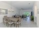 Living room and dining area with sliding doors to the lanai and lots of sunlight at 12470 Wellen Golf St # 207, Venice, FL 34293