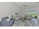 Bright living room with couches, and a sliding door to the lanai with a great view at 12470 Wellen Golf St # 207, Venice, FL 34293