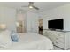 Spacious main bedroom with ensuite bathroom, a dresser and contemporary ceiling fan at 12470 Wellen Golf St # 207, Venice, FL 34293