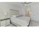 Comfortable main bedroom with a queen-sized bed and a glimpse of the ensuite bathroom at 12470 Wellen Golf St # 207, Venice, FL 34293