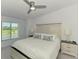 Serene main bedroom showcasing a plush bed, nightstands, and a window with a view at 12470 Wellen Golf St # 207, Venice, FL 34293