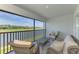 Charming screened patio featuring a coffee table and cushioned chairs with a panoramic view of the golf course and lake at 12470 Wellen Golf St # 207, Venice, FL 34293