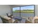Relaxing screened patio with comfortable seating, overlooking a serene golf course and water view at 12470 Wellen Golf St # 207, Venice, FL 34293